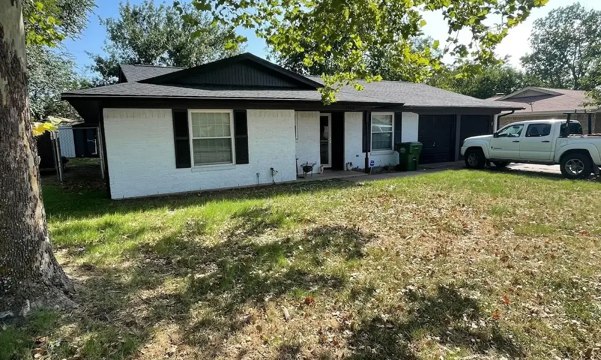 Professional roofing crew working on a residential roof in Douglas